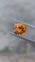 Load and play video in Gallery viewer, 2.05ct Natural Round Orange Sapphire
